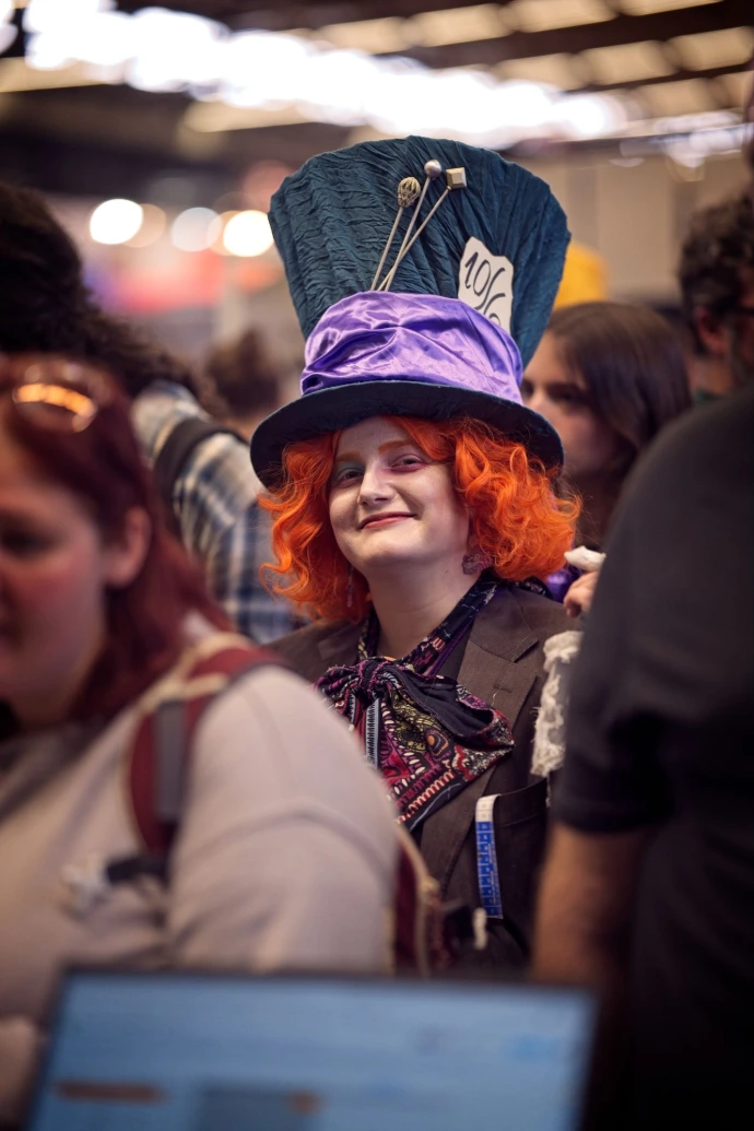 Woman in colorful Mad Hatter cosplay costume