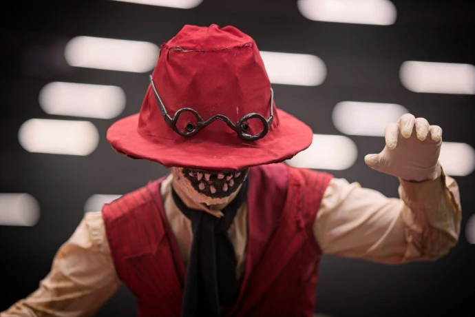 Portrait of man wearing red steampunk hat and goggles