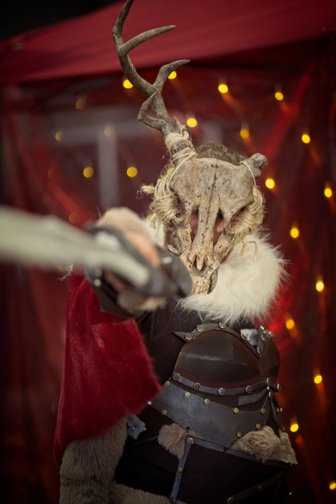 Cosplayer wearing skull mask and fur armor