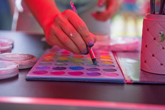 Close up of child's hands using watercolors