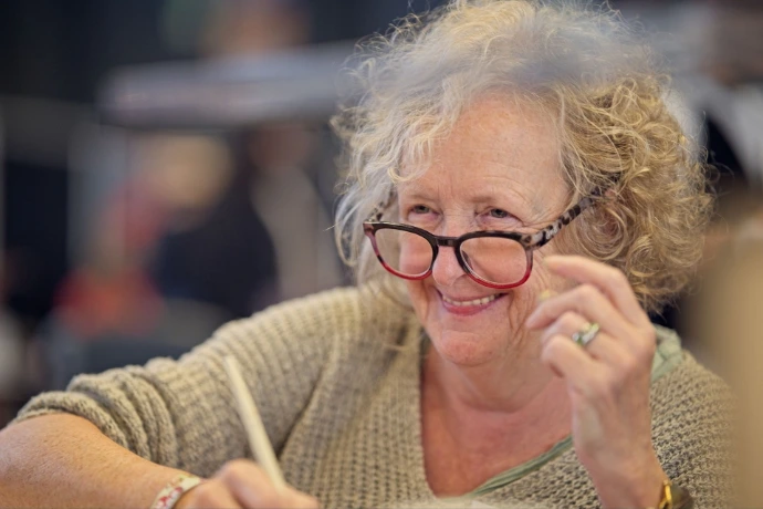 Candid portrait of smiling older woman with glasses