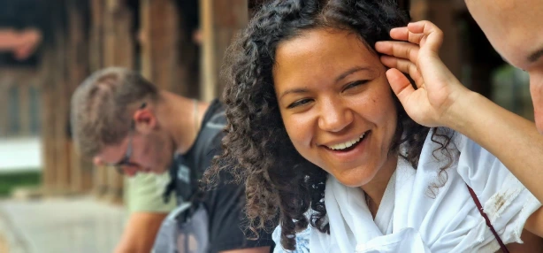 Candid portrait of smiling woman with curly hair looking away from camera