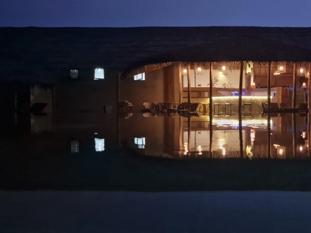 Night photography of illuminated building reflecting in water in Sri Lanka