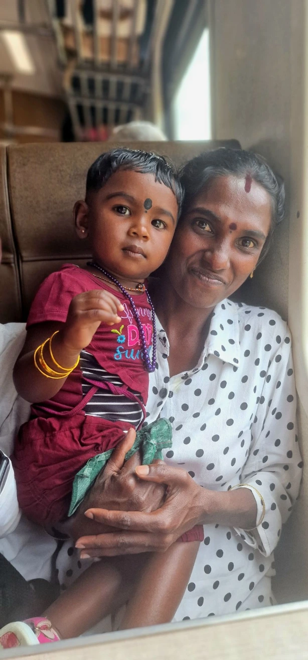 Portrait of Sri Lankan mother holding her child on a train journey